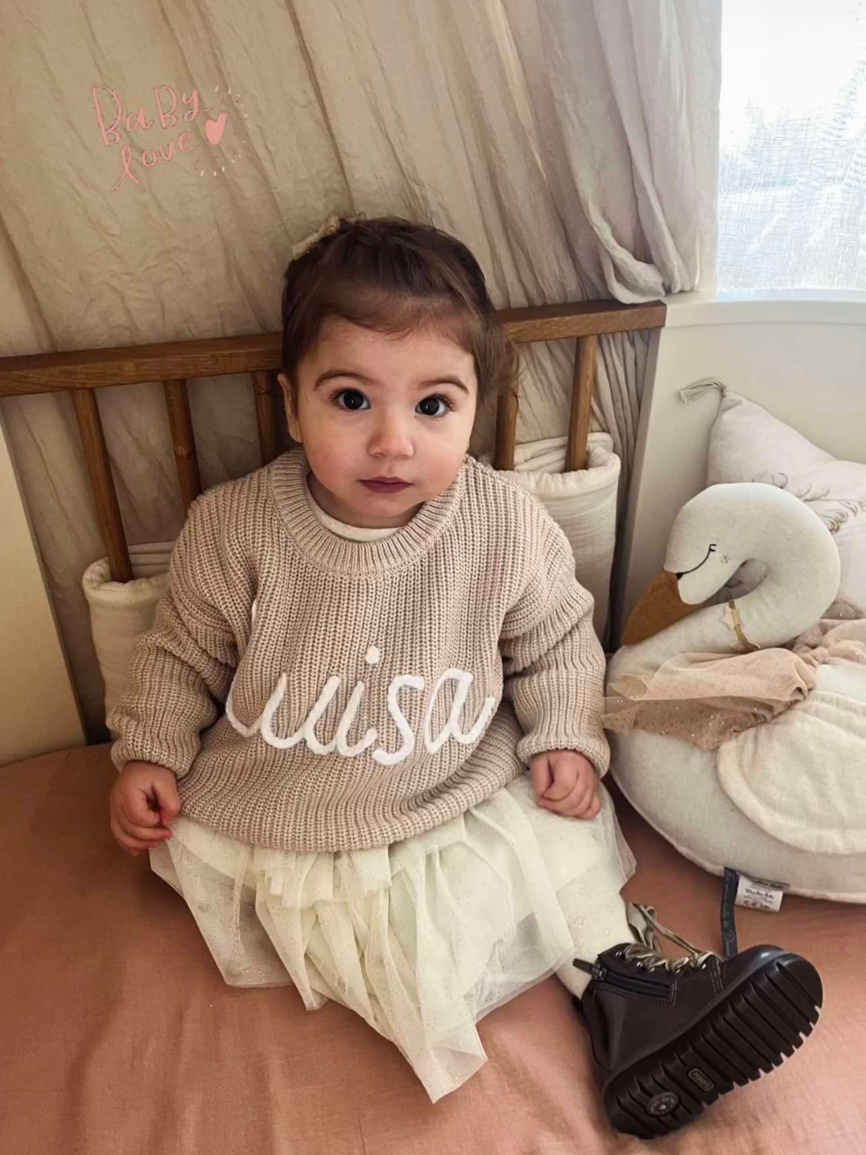 Hand-knitted embroidered baby sweater