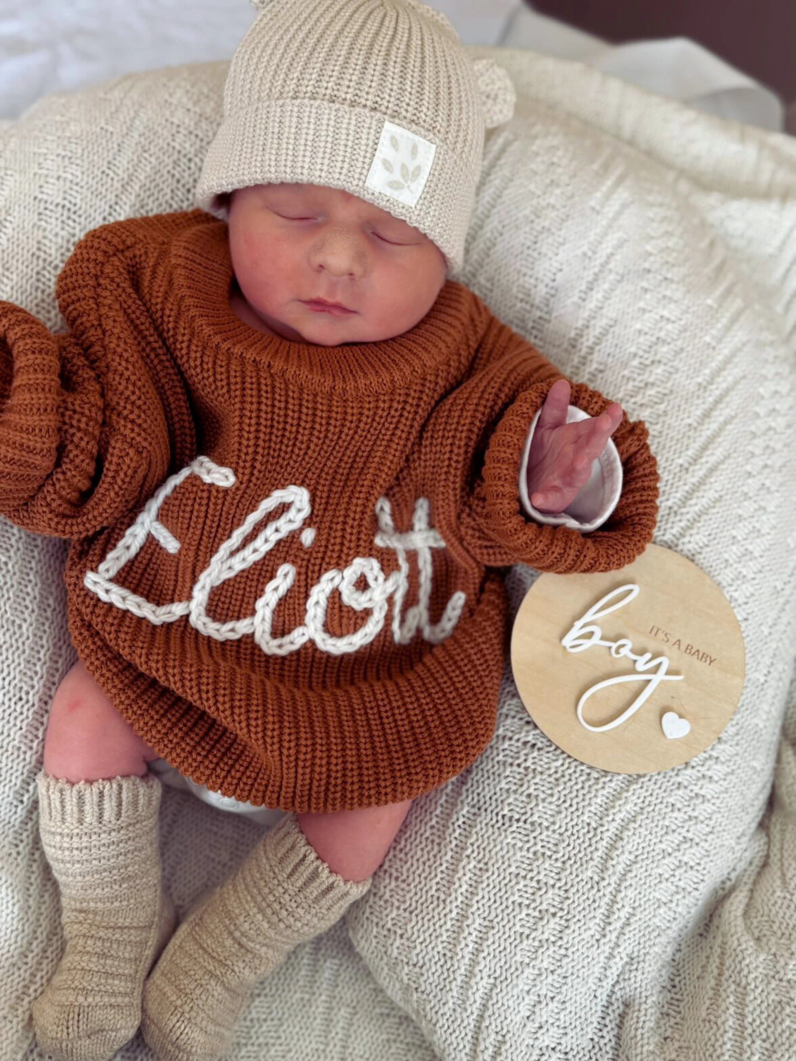 Hand-knitted embroidered baby sweater