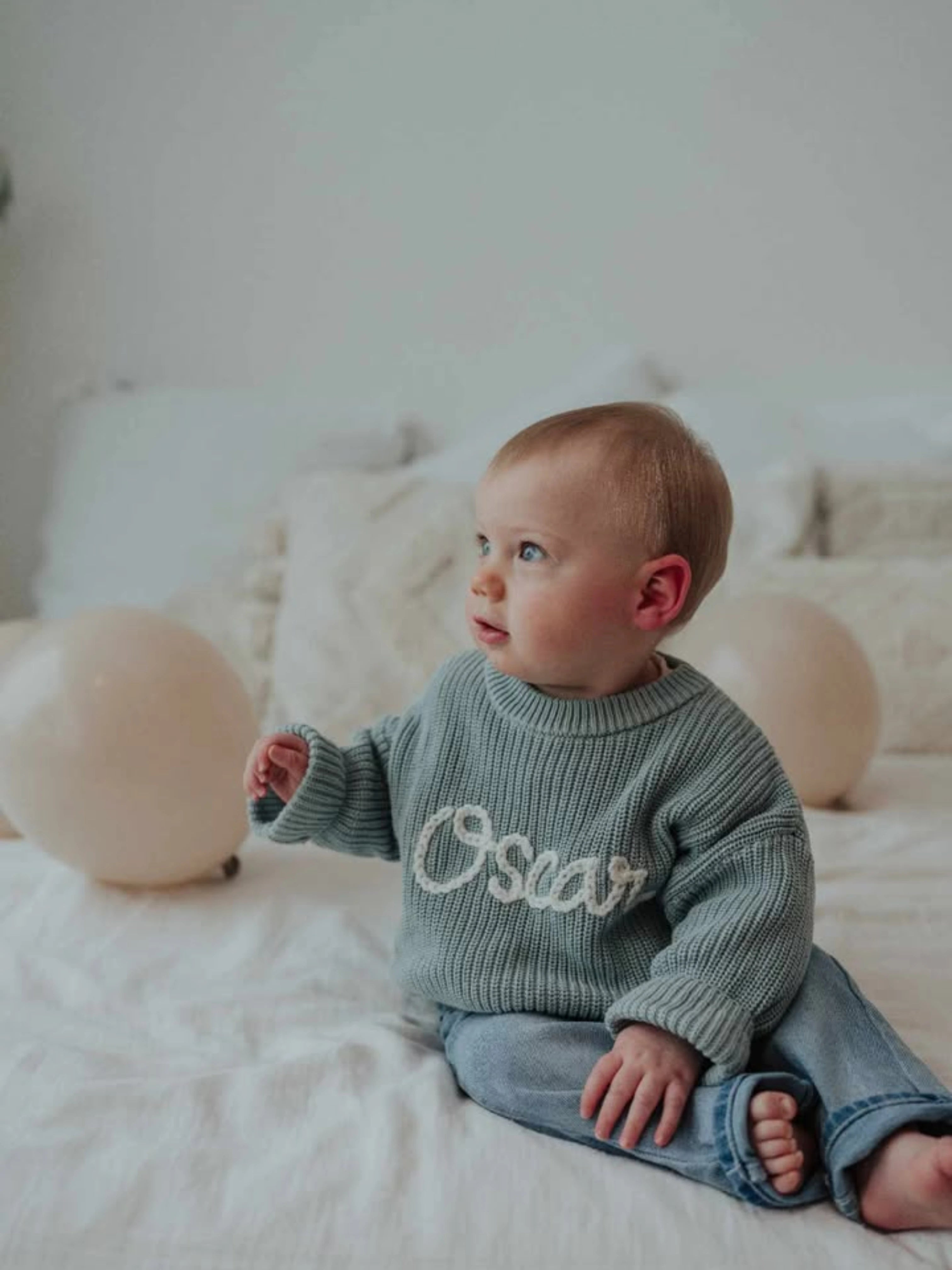 Hand-knitted embroidered baby sweater