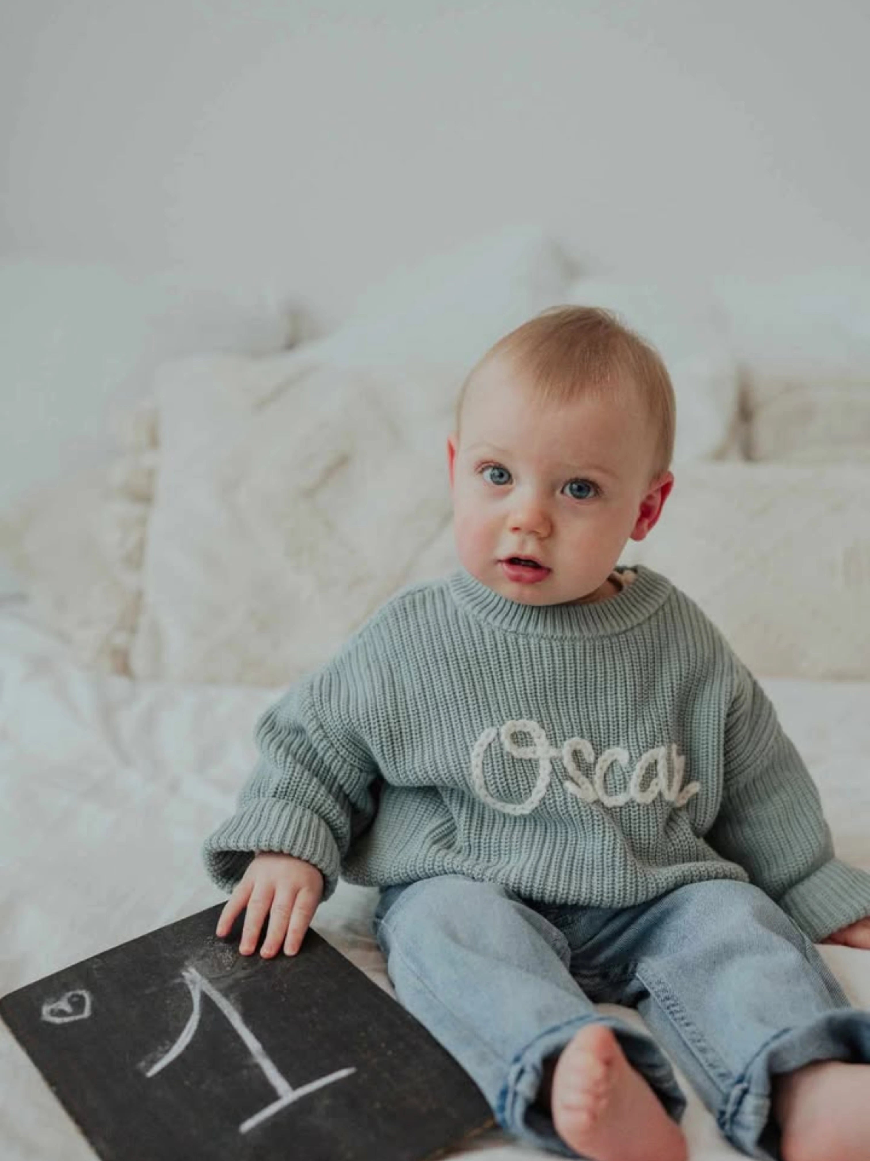 Hand-knitted embroidered baby sweater