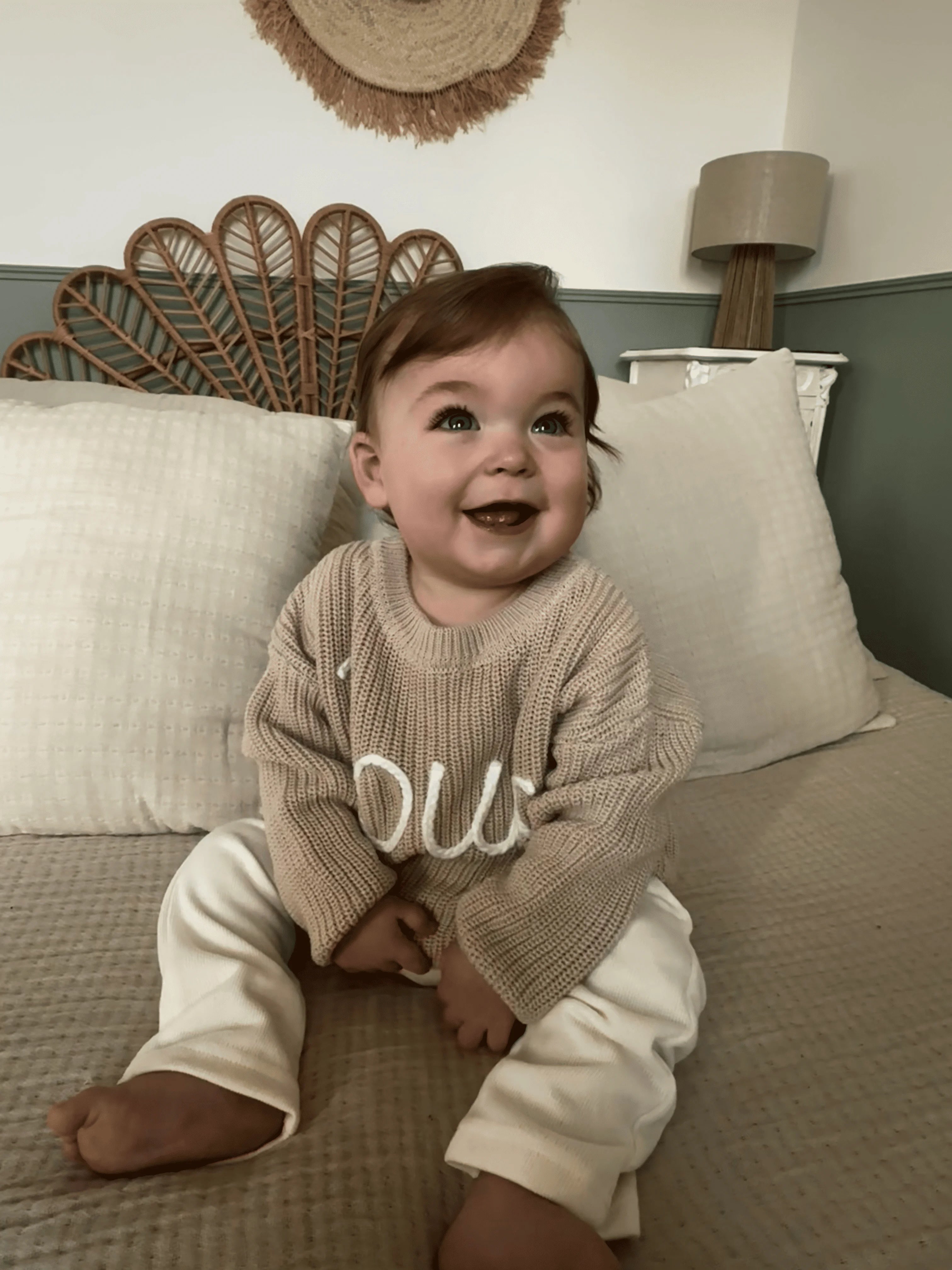 Hand-knitted embroidered baby sweater