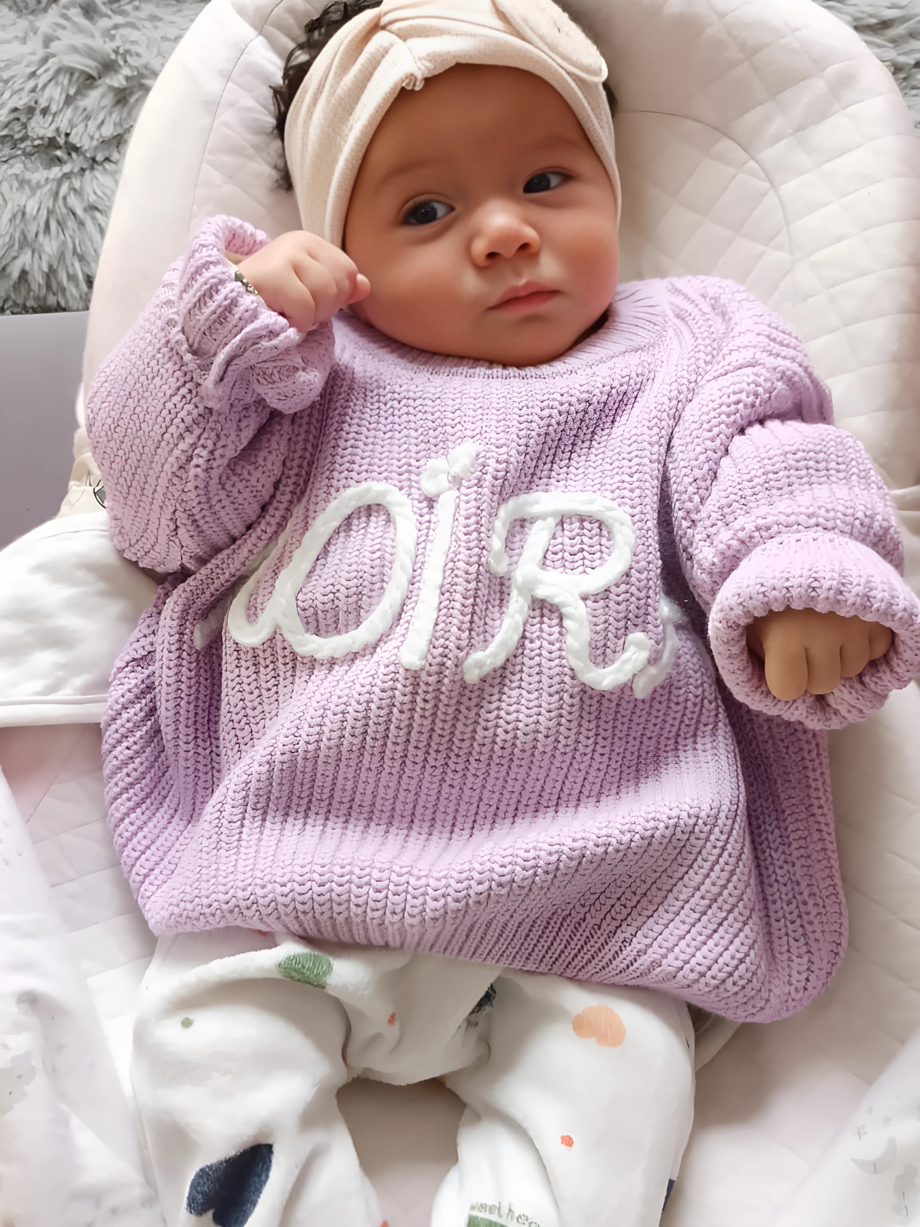 Hand-knitted embroidered baby sweater